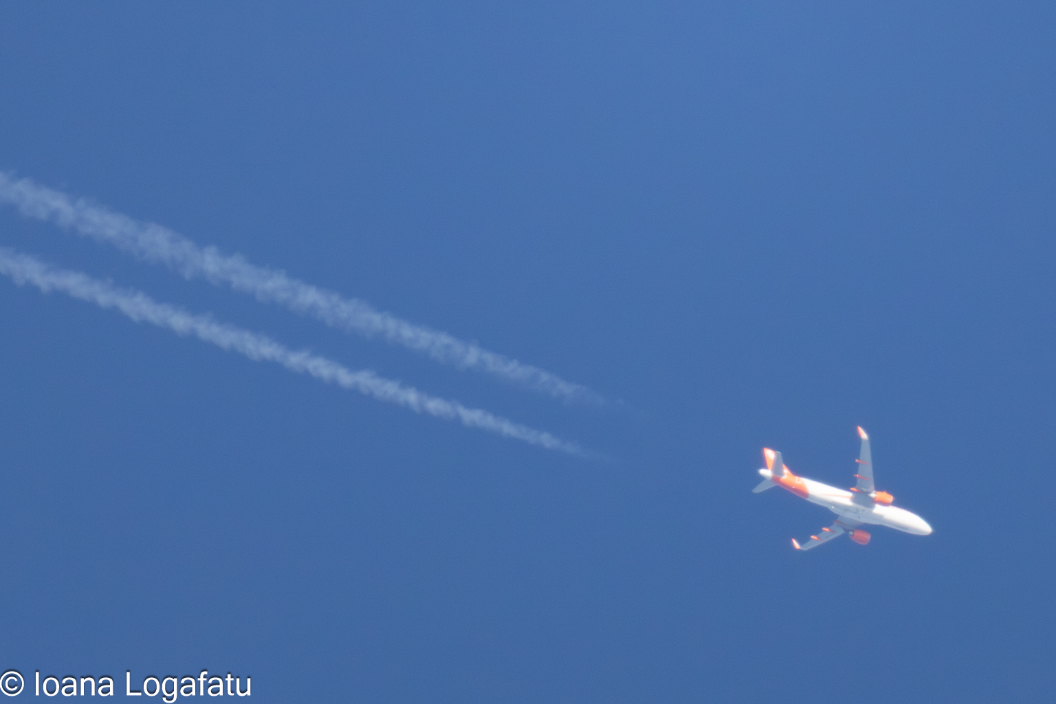 High-flying journey with trails against blue sky
